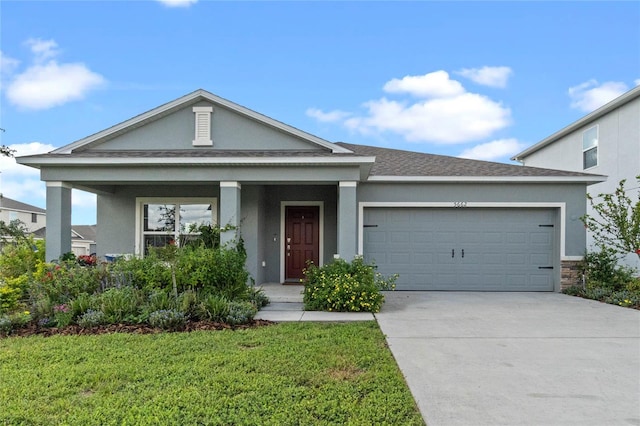 view of front of property featuring a front yard and a garage