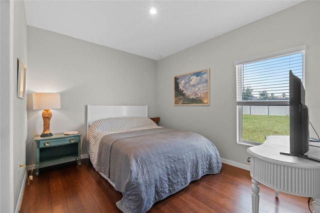 bedroom with dark wood-type flooring