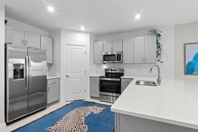 kitchen featuring gray cabinets, stainless steel appliances, and sink