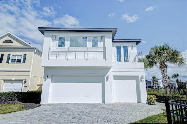 view of front of home with a balcony and a garage