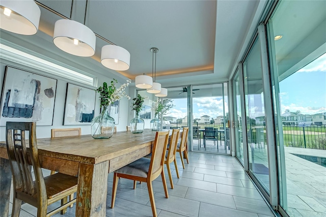 dining room with expansive windows and ceiling fan