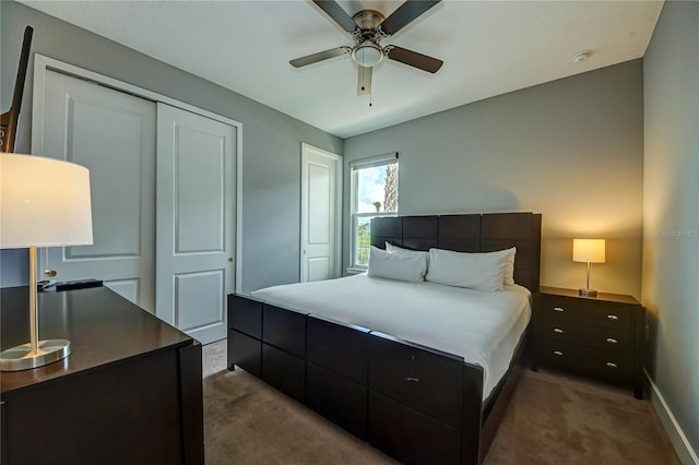 bedroom featuring baseboards, dark carpet, and ceiling fan