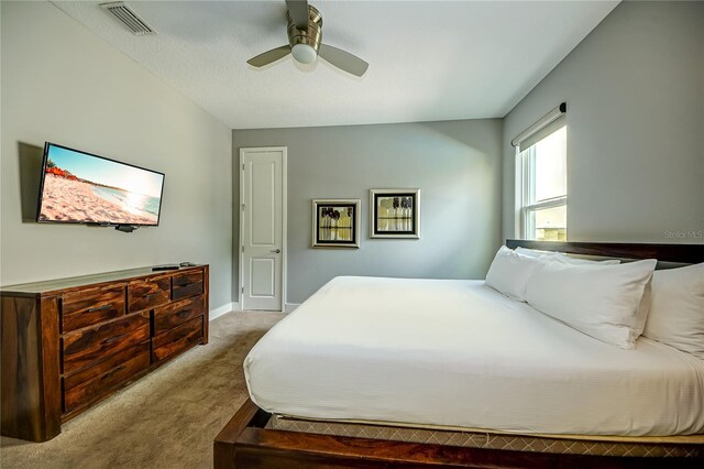 bedroom with ceiling fan and light colored carpet