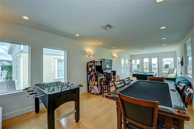 recreation room featuring baseboards, light wood-style flooring, visible vents, and recessed lighting