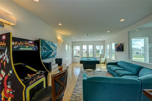 playroom with light hardwood / wood-style flooring, a healthy amount of sunlight, and billiards