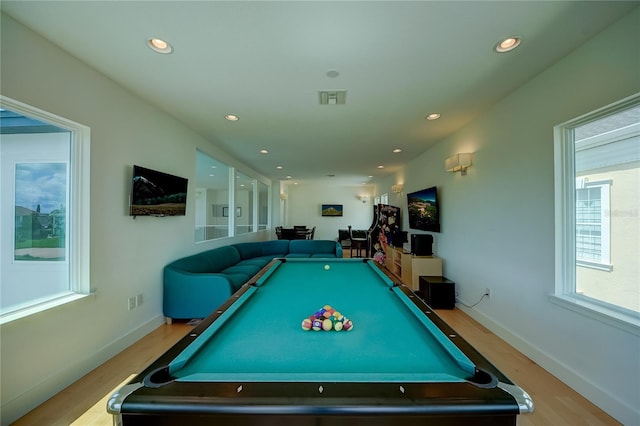 rec room featuring wood finished floors, visible vents, and a healthy amount of sunlight