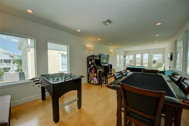 recreation room featuring light hardwood / wood-style flooring and french doors