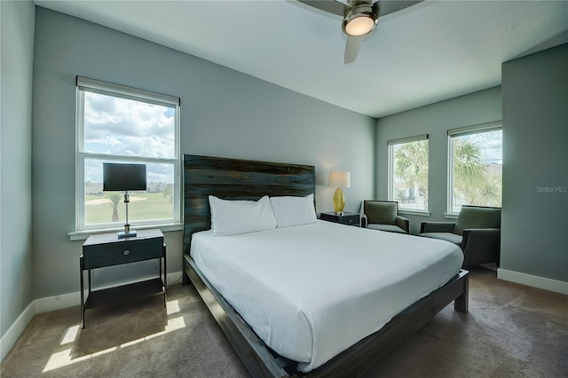 bedroom with dark carpet and ceiling fan