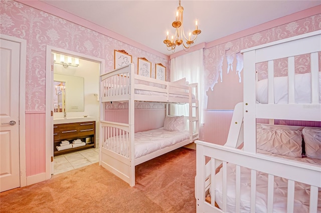 bedroom with wallpapered walls, carpet flooring, connected bathroom, and a chandelier