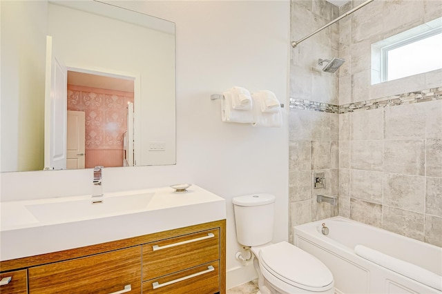 bathroom with toilet, vanity, and  shower combination