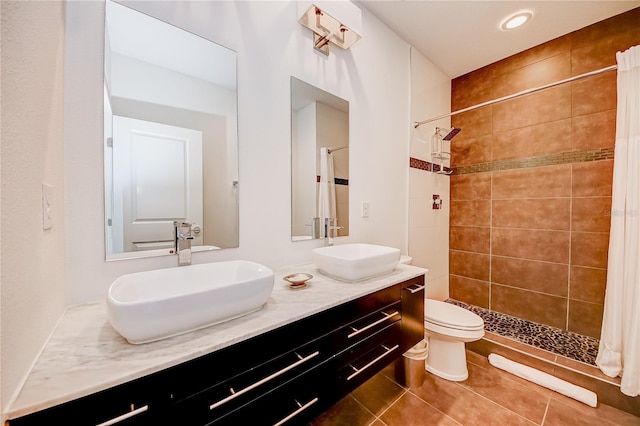 bathroom with vanity, toilet, tile patterned floors, and a shower with shower curtain