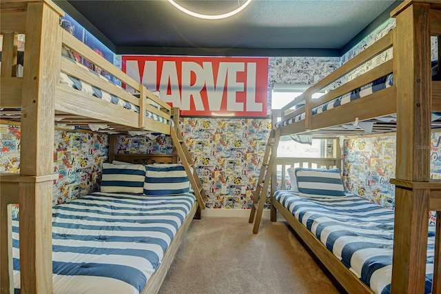 carpeted bedroom with wallpapered walls and baseboards