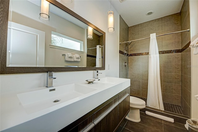 bathroom featuring vanity, a shower with curtain, toilet, and tile patterned floors