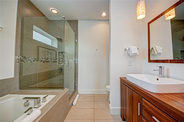 bathroom featuring a bath, tile patterned floors, baseboards, a shower stall, and vanity