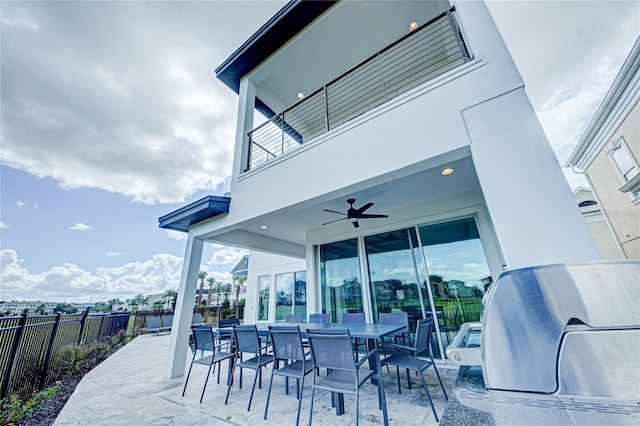 view of patio / terrace with fence, ceiling fan, a balcony, outdoor dining space, and area for grilling