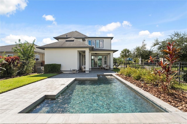 rear view of house featuring ceiling fan, a patio area, and central air condition unit