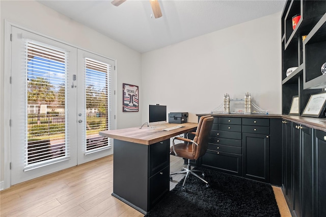 home office featuring light wood-type flooring and ceiling fan