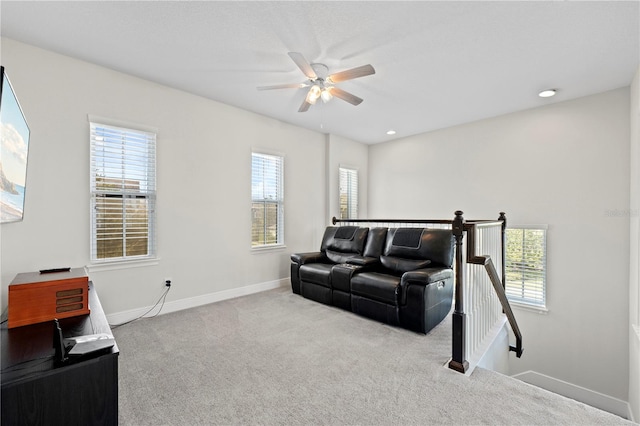 carpeted living room with ceiling fan