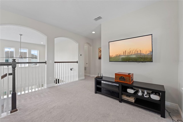 interior space featuring carpet and a notable chandelier