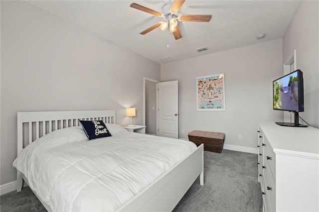 carpeted bedroom featuring a textured ceiling and ceiling fan