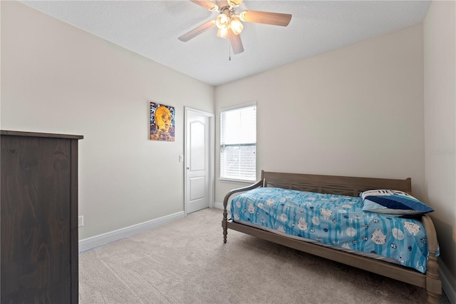 bedroom with ceiling fan and light carpet