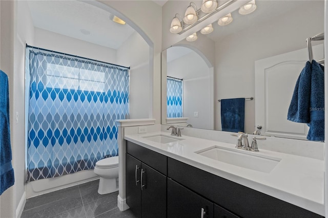 full bathroom with shower / bath combo with shower curtain, tile patterned flooring, vanity, and toilet