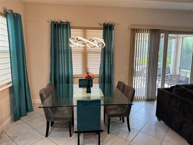 tiled dining room with plenty of natural light and a chandelier