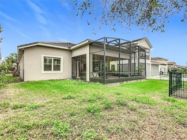 rear view of property with a fenced backyard, a lawn, and stucco siding