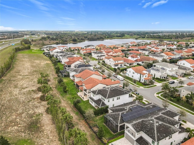 drone / aerial view with a water view and a residential view