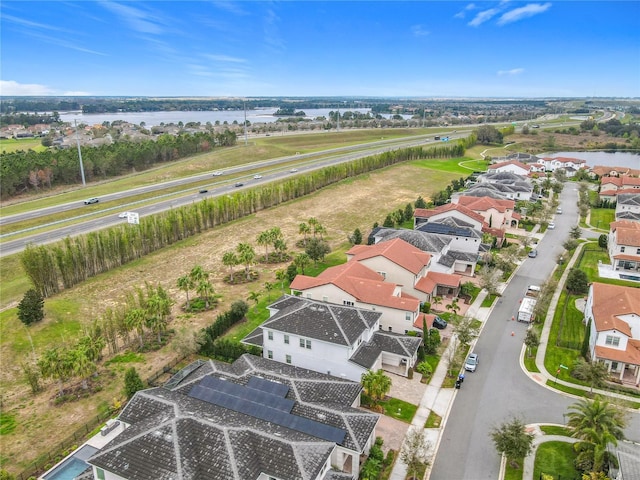 drone / aerial view with a residential view and a water view