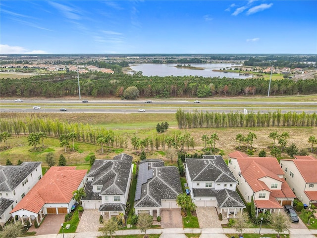 bird's eye view with a water view and a residential view