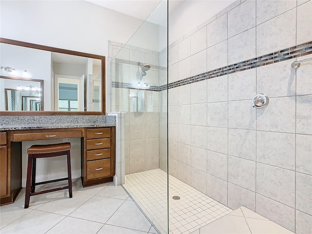 bathroom featuring tile patterned floors, vanity, and walk in shower