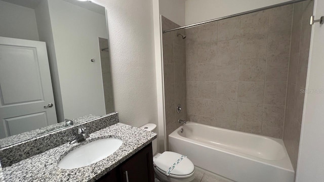 full bathroom featuring vanity, tiled shower / bath combo, and toilet