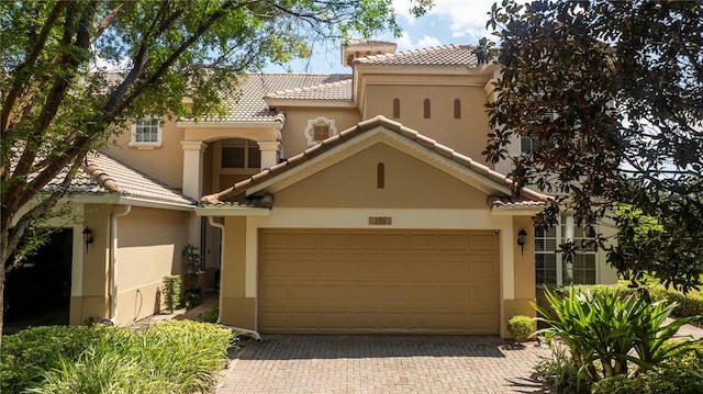 mediterranean / spanish house with a garage