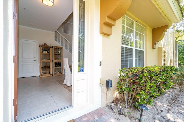 property entrance with covered porch and stucco siding