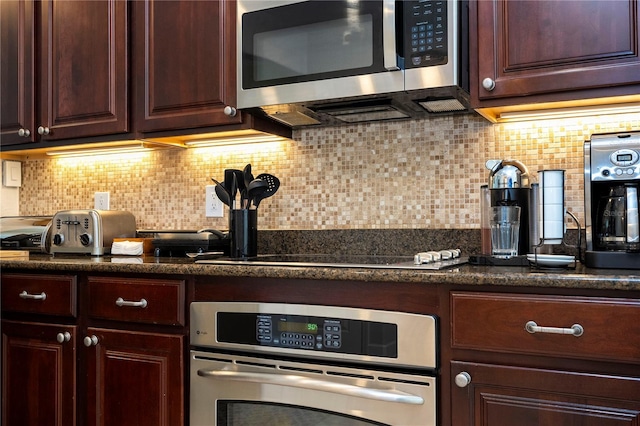 kitchen with appliances with stainless steel finishes, backsplash, and dark brown cabinets