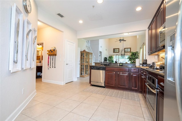 kitchen featuring light tile patterned floors, stainless steel appliances, ceiling fan, dark brown cabinetry, and sink