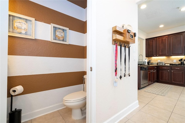 bathroom featuring tile patterned flooring, vanity, and toilet