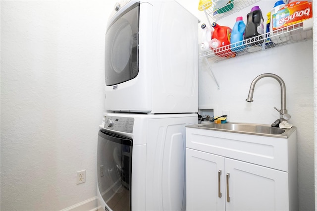 clothes washing area with sink and stacked washing maching and dryer