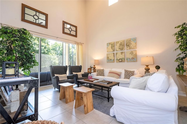 living room with a high ceiling and light tile patterned flooring