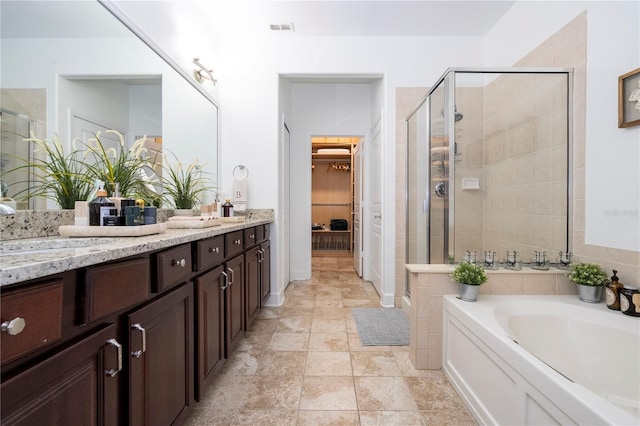 full bathroom with a sink, a stall shower, double vanity, and visible vents