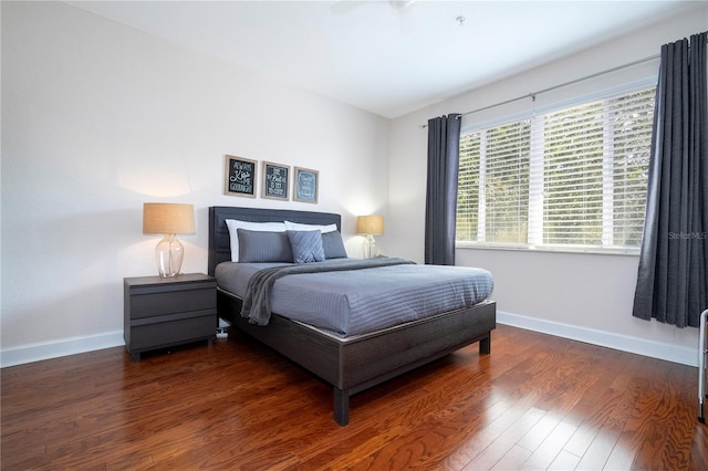 bedroom with ceiling fan and dark wood-type flooring