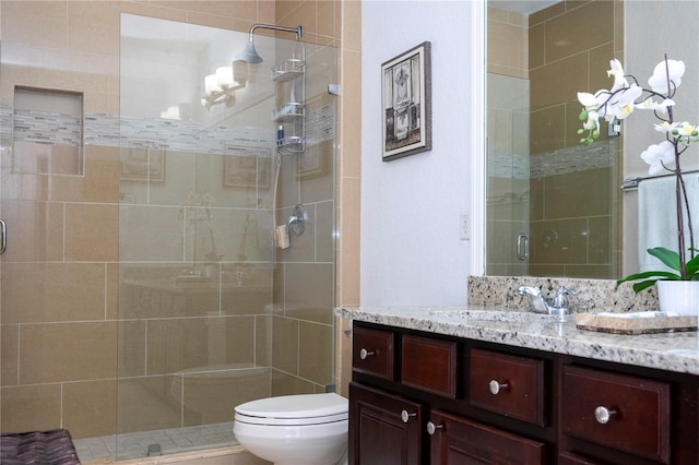 bathroom featuring walk in shower, vanity, and toilet