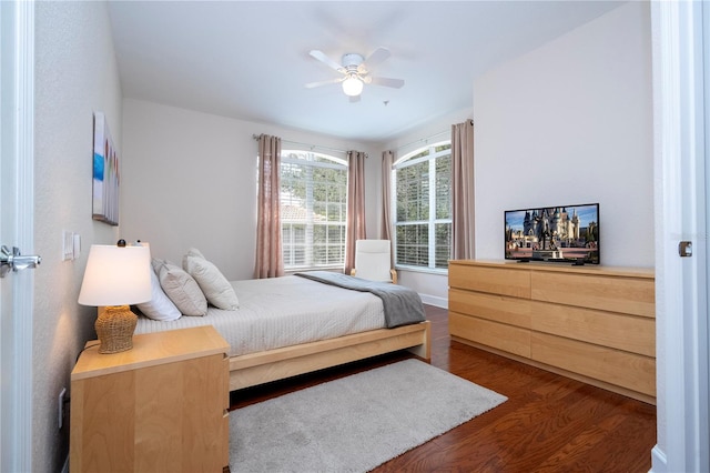 bedroom with ceiling fan and dark wood-type flooring