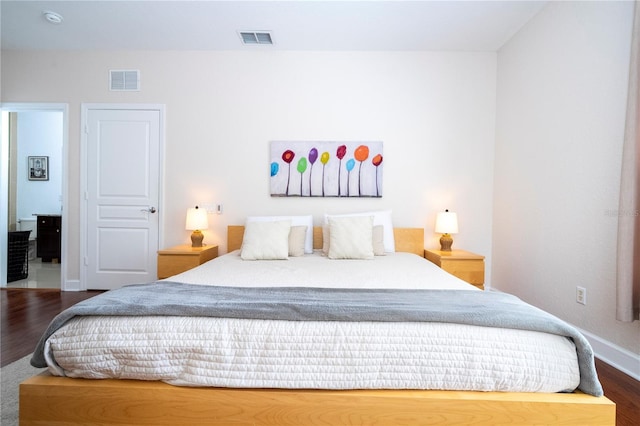 bedroom with dark hardwood / wood-style flooring