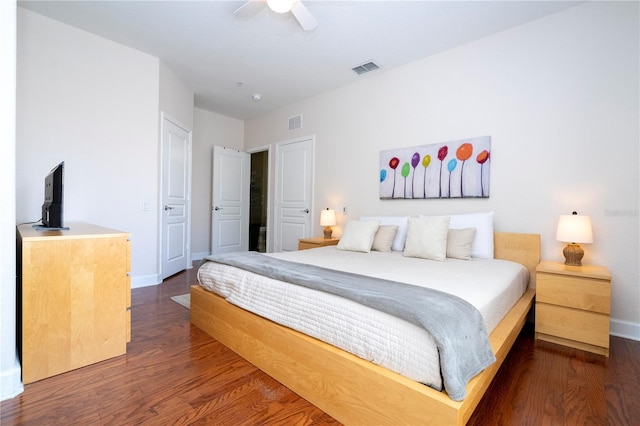 bedroom with baseboards, visible vents, and dark wood-style floors