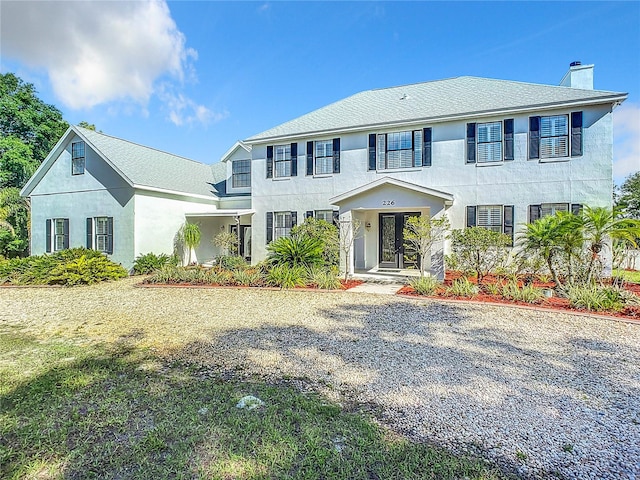 colonial-style house with french doors