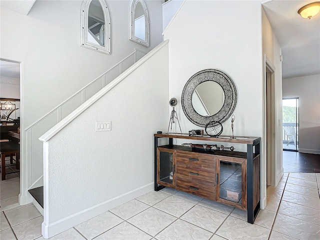 staircase featuring tile patterned floors