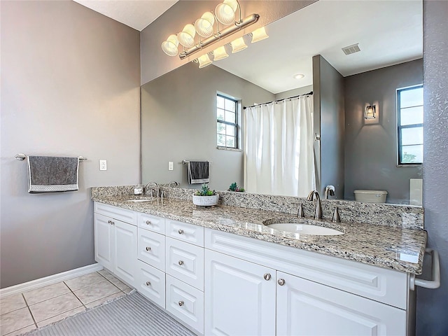 bathroom with tile patterned floors, vanity, and toilet