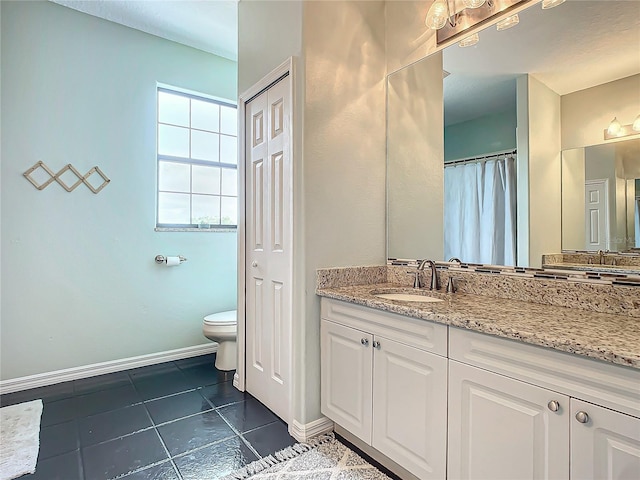 bathroom featuring tile patterned flooring, vanity, and toilet